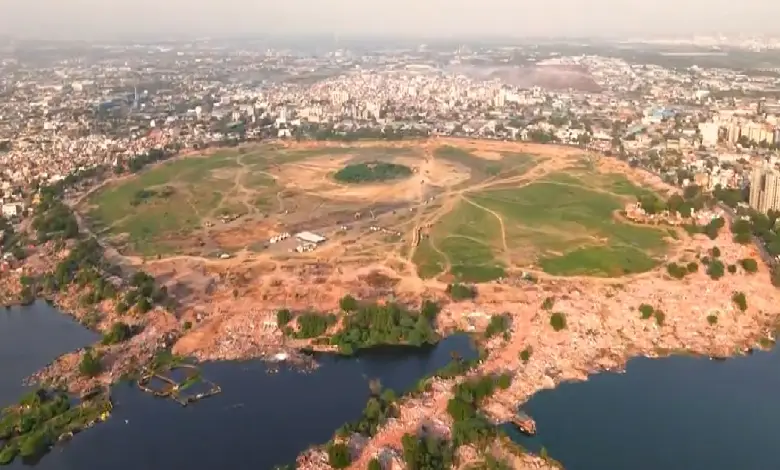 Drone view of Chandola Lake after encroachment demolition, showing cleared land and ongoing lake restoration work.