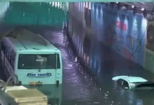 Stranded vehicles submerged in flooded Delhi underpass during severe overnight rain, highlighting widespread urban inundation. | Image: DD News
