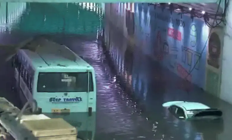 Stranded vehicles submerged in flooded Delhi underpass during severe overnight rain, highlighting widespread urban inundation. | Image: DD News