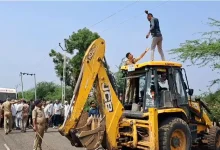 Farmers protest pipeline project at Dhatarwadi Dam in Rajula; some climb JCBs, detained by police amid escalating tensions.