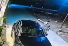 Mercedes car on fire in Surat’s Vesu, caught on CCTV; arson linked to possible enmity, police investigating suspects on scooter.