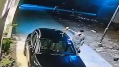 Mercedes car on fire in Surat’s Vesu, caught on CCTV; arson linked to possible enmity, police investigating suspects on scooter.