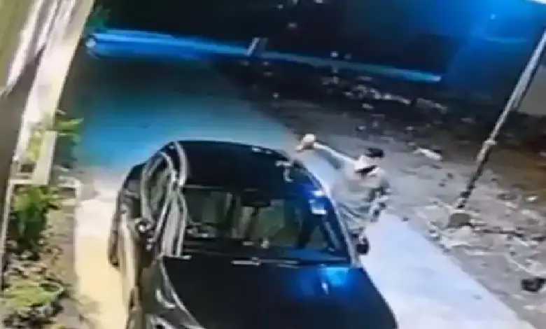Mercedes car on fire in Surat’s Vesu, caught on CCTV; arson linked to possible enmity, police investigating suspects on scooter.