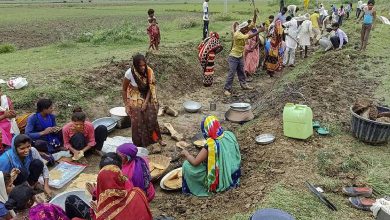 "Rural workers at MGNREGA job site as study shows declining workdays despite growing household registrations in India."