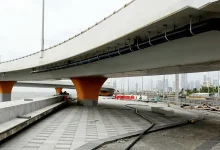 Mumbai Coastal Road promenade nearing completion, featuring lush greenery and a wide walking path by the sea.