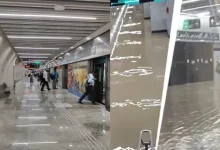 Mumbai Metro station entrance during a heavy monsoon downpour, with rain preparedness measures underway.
