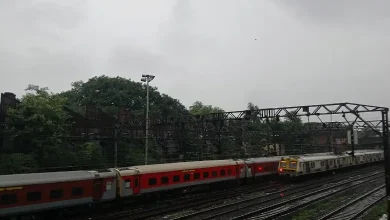 Heavy monsoon rains in Mumbai causing waterlogging, with dark clouds and lightning overhead.