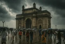 Mumbai skyline during pre-monsoon showers with overcast skies and light rainfall.