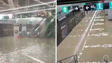 Flooded Mumbai Metro 3 Aqua Line station with knee-high water after heavy monsoon rains.