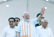 Prime Minister Narendra Modi addresses a large public gathering in Gujarat, inaugurating development projects.