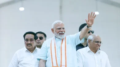 Prime Minister Narendra Modi addresses a large public gathering in Gujarat, inaugurating development projects.