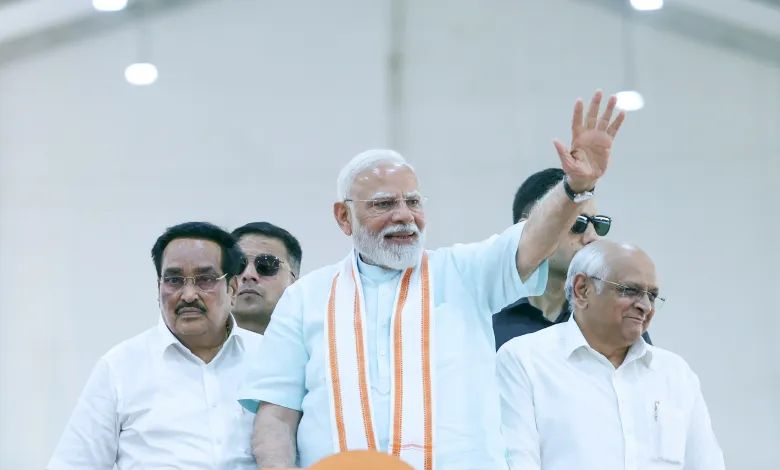 Prime Minister Narendra Modi addresses a large public gathering in Gujarat, inaugurating development projects.