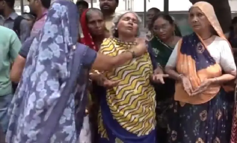 Family members mourn the deaths of three workers who drowned in a tank during night shift cleaning operation.