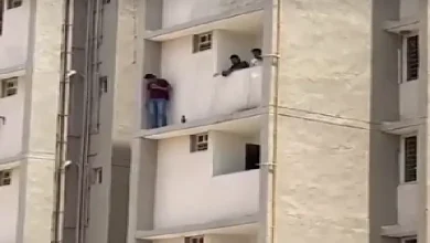 Ahmedabad suspect on apartment ledge during police standoff in kidnapping case at Shivam Aawas Yojana flats.