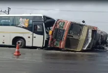 Overturned edible oil tanker and damaged bus after highway collision near Bhootvad Chowkdi in Gujarat.