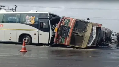 Overturned edible oil tanker and damaged bus after highway collision near Bhootvad Chowkdi in Gujarat.