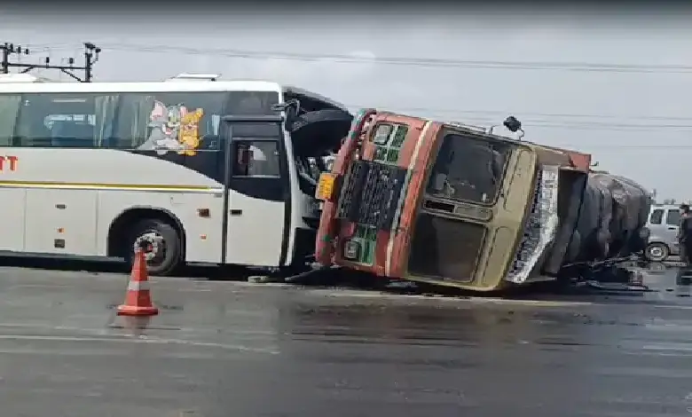 Overturned edible oil tanker and damaged bus after highway collision near Bhootvad Chowkdi in Gujarat.