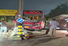AMTS bus accident in Ahmedabad’s Jamalpur area; vehicle damaged after hitting pole and landing on road divider.