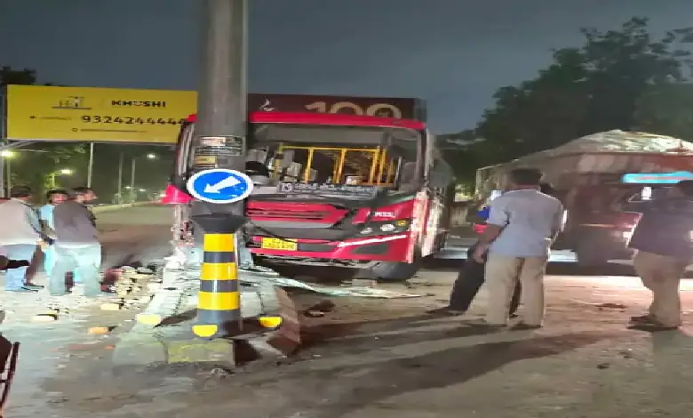 AMTS bus accident in Ahmedabad’s Jamalpur area; vehicle damaged after hitting pole and landing on road divider.