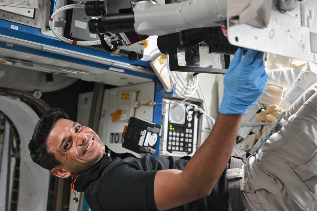 With a smile that speaks of dreams fulfilled, Shubhashu Shukla works on an experiments in microgravity aboard the ISS. | NASA