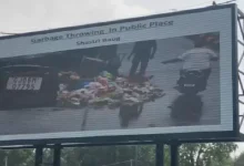 LED screen in Vadodara displaying photo of littering offender as part of digital cleanliness and public shaming campaign.