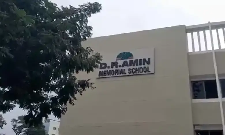 Vadodara police at DR Amin School after bomb threat e-mail; bomb squad conducts search for RDX.