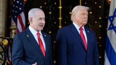 Israel's Prime Minister Benjamin Netanyahu speaks to reporters as President Donald Trump listens at the Mar-a-Lago club, on December 29, 2025, in Palm Beach, Florida