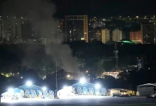 Airplanes roared overhead and explosions shook the streets of Caracas early Saturday, with a thick plume of smoke rising over the Venezuelan capital as power went out near a major military base.