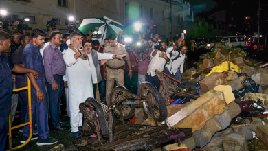Karnataka Deputy Chief Minister DK Shivakumar visits the site of a wall collapse following heavy rain. (Image: PTI)