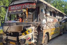Damaged luxury bus and truck on the Vadodara-Ahmedabad Expressway in Anand district after the collision