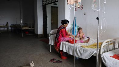 Health worker administering measles vaccine to child during Bangladesh outbreak response